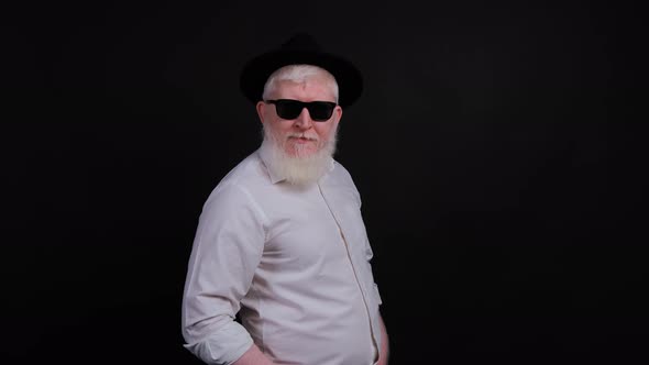 Portrait of Bearded Handsome Young Man with Albinism That Is Posing Over Black Background