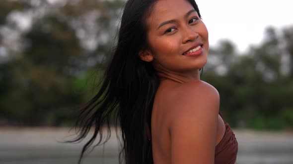 Young Woman Looking To Camera On Beach