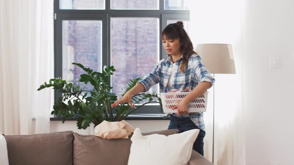 Asian Woman Picking Dirty Laundry at Home