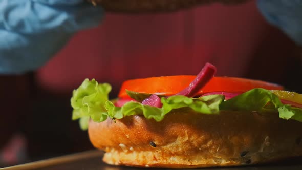 Close-up Top View of a Cook's Hands Cooking a Hamburger