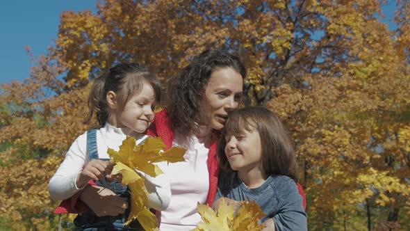 Mother with Children in the Autumn Park