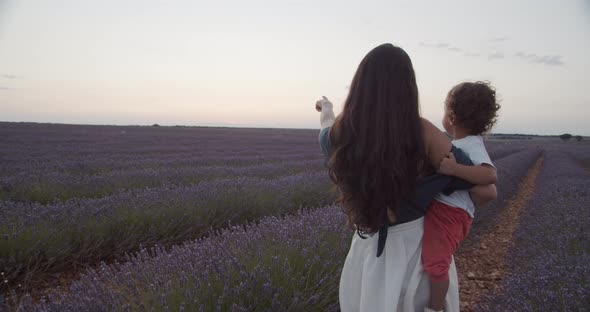 Woman and little child together in lavender field