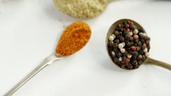 Various spices in spoon on white background 4k