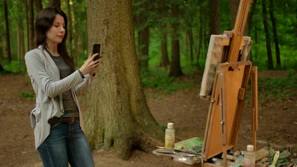 Girl Artist Takes a Picture of Her Painted Picture on a Smartphone