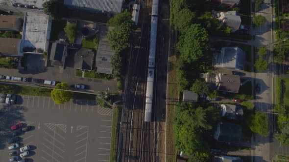 Top Down Aerial Following Shot of a Train Passing Through Port Washington