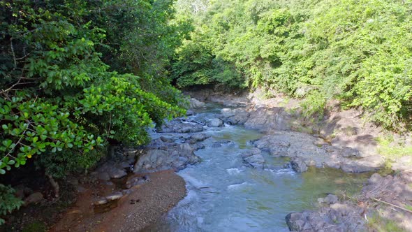 Aerial forward low altitude over Higuero creek at La Cuaba in Dominican Republic