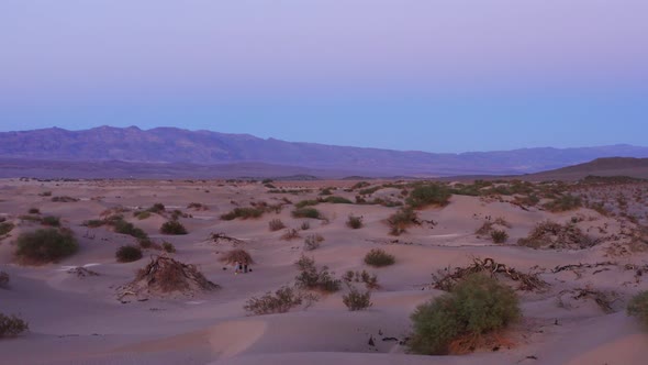 Drone circles around the desert very close to the sand dunes. Beautiful sunset