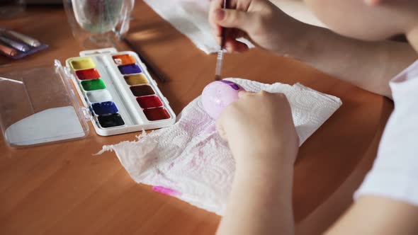 Two Sisters Painting Easter Eggs