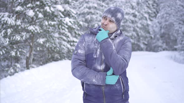 Frozen Man on the Background of Snow Pensive and Found the Answer To Your Question