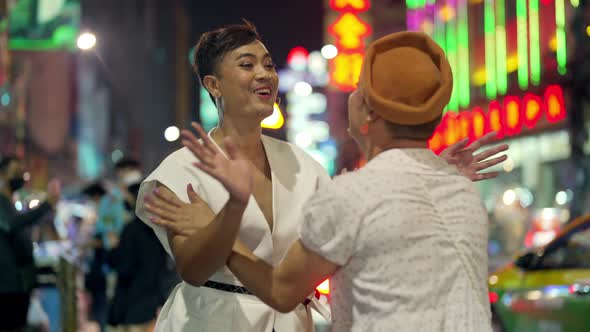 4K Asian lgbtq guy friends in woman clothes meeting together in the city at night.