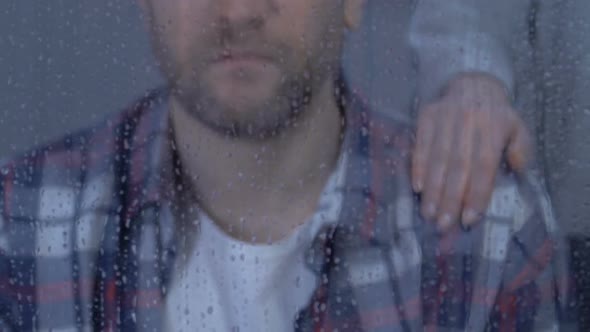 Female Comforting Unhappy Male Looking in Window at Rainy Day, Family Support