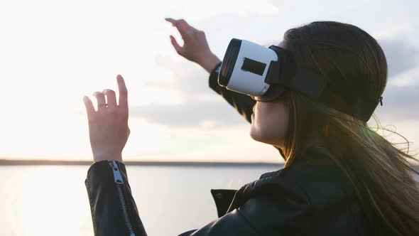 Portrait of Young Woman in Vr Glasses Outdoors with Beatiful Sea Sunset Background Slow Motion