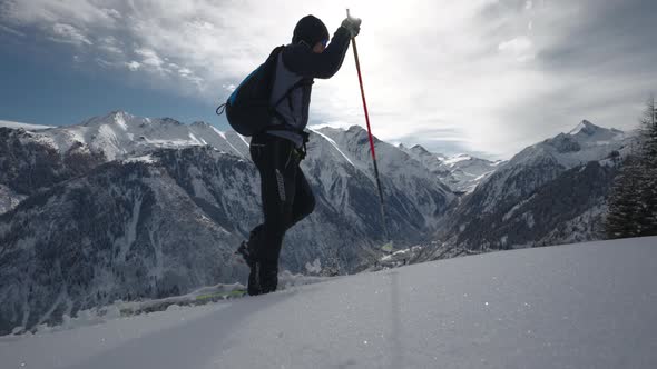 Man Ski Touring In Snow Covered Forest