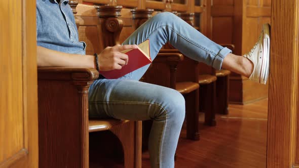 Man reading a book in the library 4k