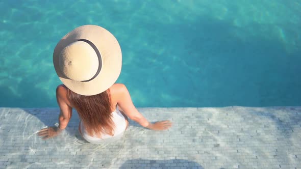 Young asian woman enjoy around outdoor swimming pool for leisure