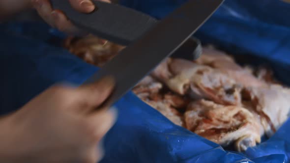 Closeup of Female Hands Sharpening Knife in the Kitchen Before Cutting the Meat