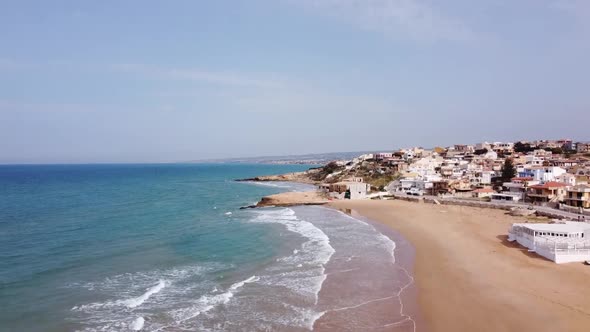 the stunning beach of cava d'aliga in sicily, drone soaring high, sunny (italy)