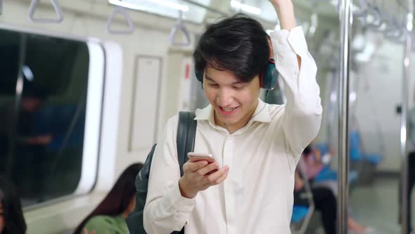 Businessman Using Mobile Phone on Public Train