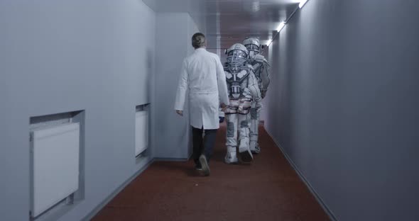 Astronauts Walking Down Corridor