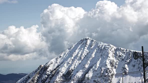 Timelapse of a snowy mountain while a storm is coming. 4K