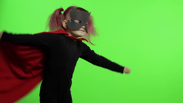 Funny Child Girl in Costume and Mask Plays Super Hero. National Superhero Day