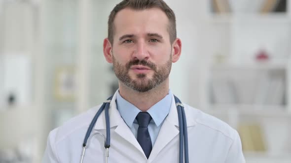 Portrait of Professional Male Doctor Talking on Video Call