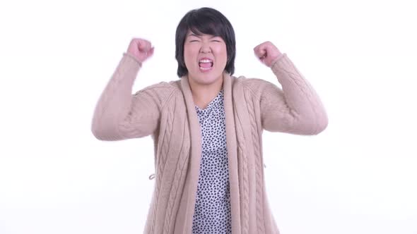 Happy Overweight Asian Woman Getting Good News Ready for Winter