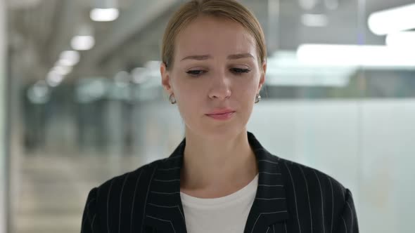 Sad Young Businesswoman Crying at Camera