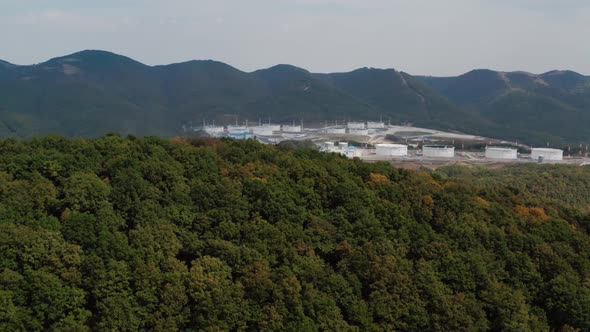 Large tank farm in the mountains with dense vegetation