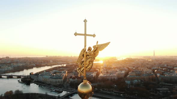 Flying Around an Angel on Spire of Peter and Paul Fortress at Sunset, Close-up. Panorama of St