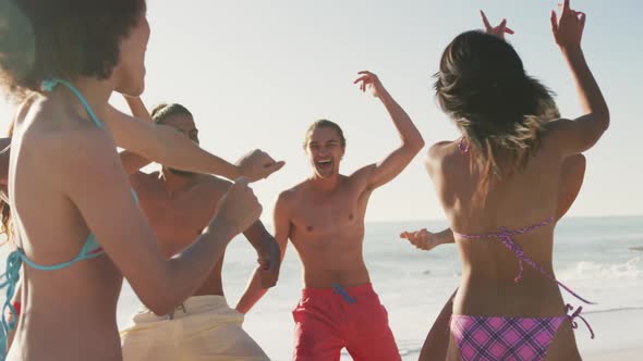 Friends dancing at beach