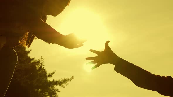 Girls Travelers Help Each Other Conquer the Top of a High Mountain, Holding Hands and Pulling Each