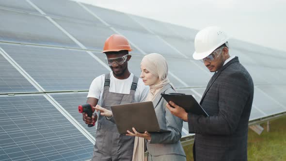 Multiracial People Controlling Temperature of Solar Panels