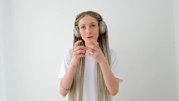 Smiling Woman Talking on Smartphone in Wireless Headphones