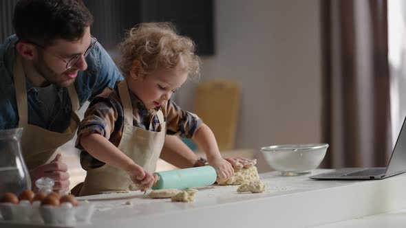 Cute Toddler with Funny Curls is Playing at Kitchen Rolling Out Dough Masterclass From Father Dad