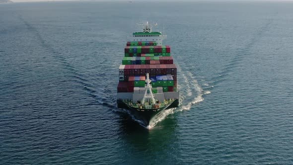 Front View of Ultra Large Container Ship Sailing at Sea Aerial Shot