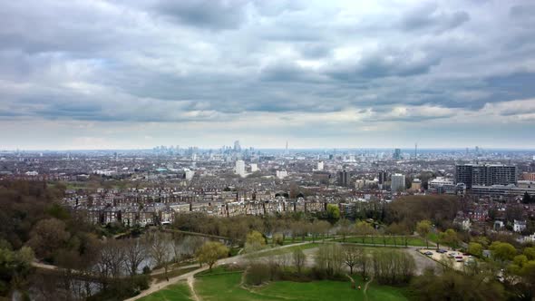 Wide aerial view of City of London from Hampstead Heath on cloudy day