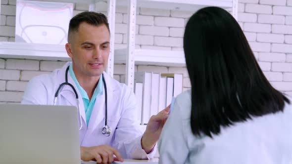 Doctor in Professional Uniform Examining Patient at Hospital