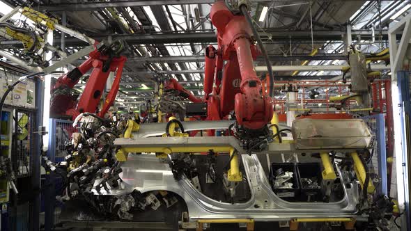Modern Robotic Arm Lifting Car Frame in Factory 4K