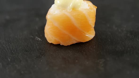 Sushi served on grey stone slate