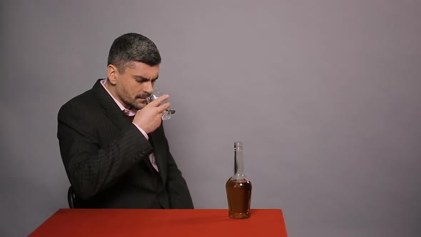 Displeased Man Smelling, Tasting Cheap Scotch, Dissatisfied Guest in Restaurant