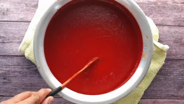 Tomato Sauce in a Small Jar with Fresh Tomato on Table