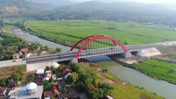 Red Kali Kuto bridge on Trans Java toll road, Indonesia, aerial orbital view