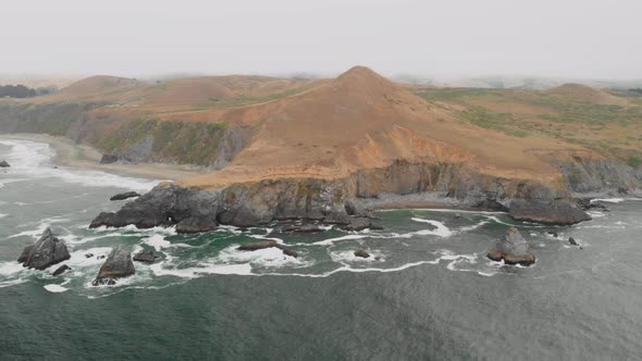 Expansive aerial view of a large hill along the Sonoma Coast in California.