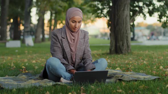 Muslim Arab Islamic Student Girl in Hijab Business Woman Freelancer User Uses Laptop Sitting on