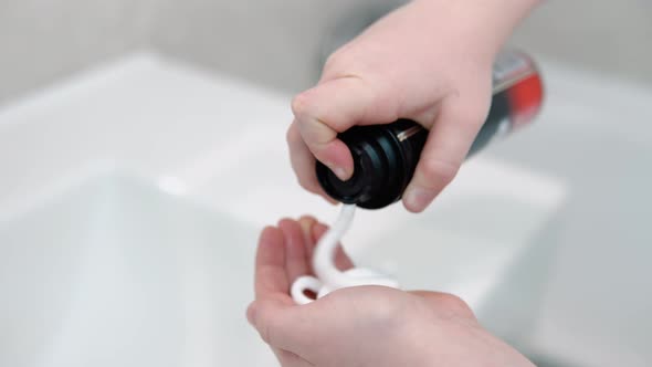 Little Boy Applying Shaving Foam to Hand in the Bathroom