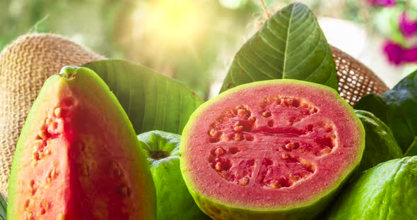 Red guavas sliced and sunset in the background