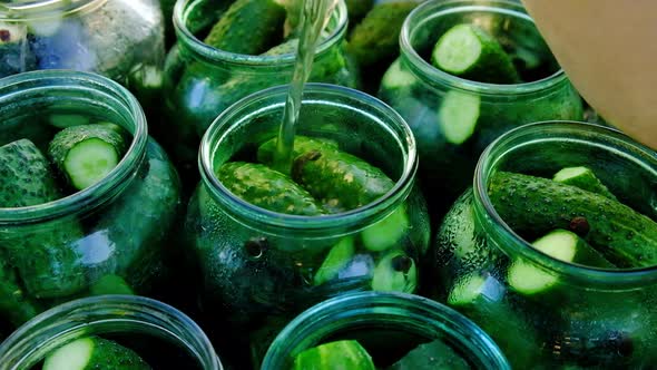 Cucumber Pickle Is Poured Into a Jar