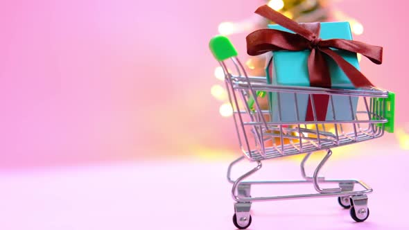 Present Box with a Ribbon in a Shopping Trolley Cart