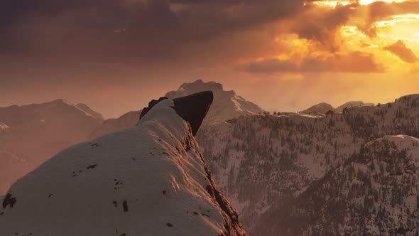 Snow on Top of a Rocky Mountain Peak with Nature Landscape in Background